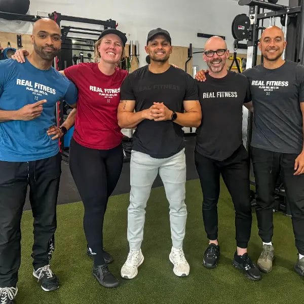 Coaches and members standing together at Real Fitness gym